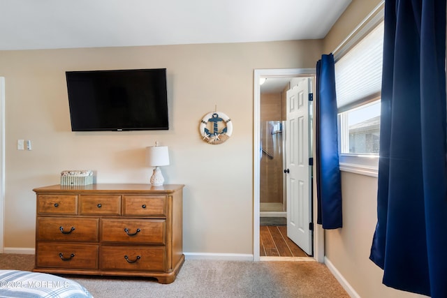 bedroom with light carpet and connected bathroom