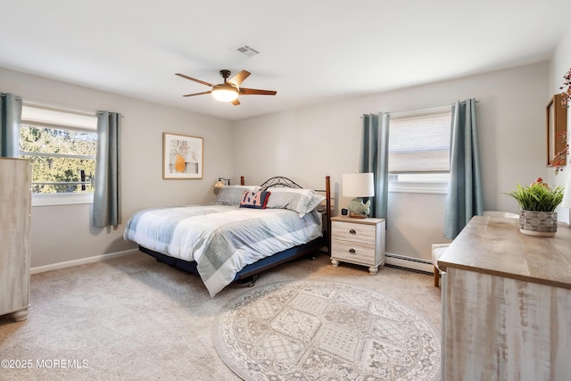 bedroom featuring a baseboard heating unit, ceiling fan, and light carpet