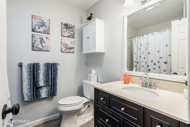 bathroom featuring toilet and vanity