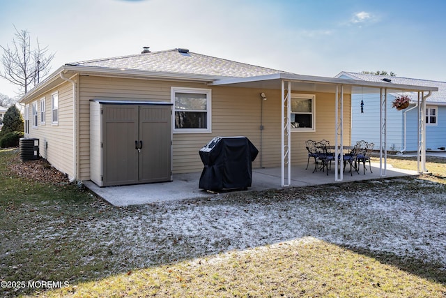 rear view of property with central air condition unit and a patio