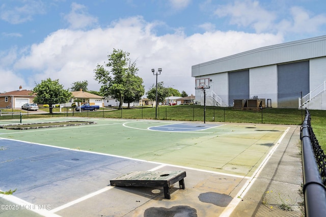 view of sport court with a yard