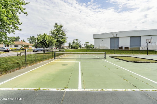 view of sport court with basketball court and a lawn