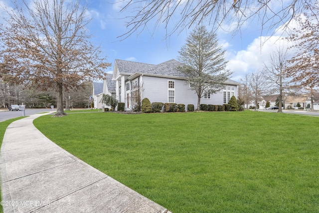 view of property exterior with a lawn