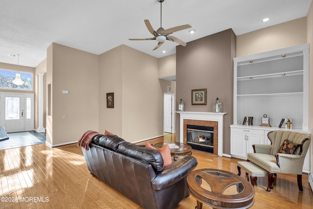 living room featuring ceiling fan and light hardwood / wood-style floors