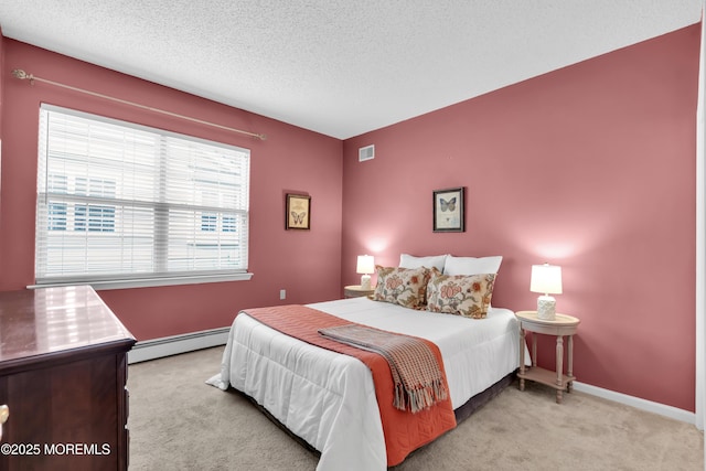 carpeted bedroom featuring a textured ceiling and baseboard heating