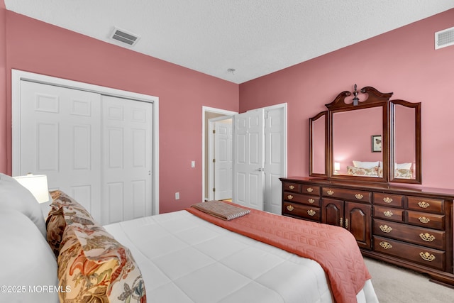 carpeted bedroom featuring a closet and a textured ceiling