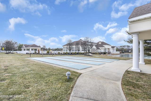 view of swimming pool with a lawn and a water view