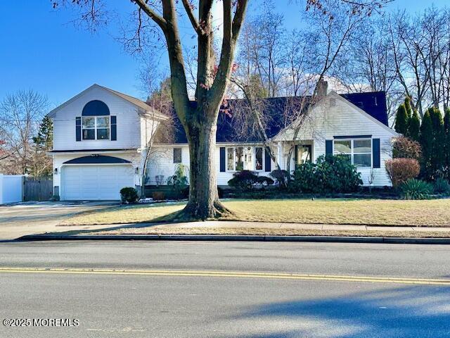 view of front of home with a front lawn and a garage