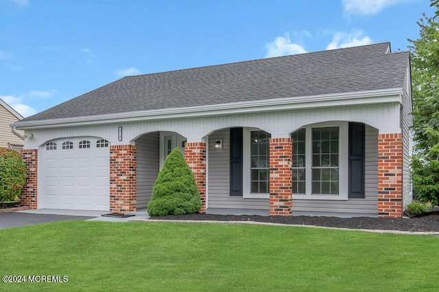 view of front of house featuring a front lawn, covered porch, and a garage