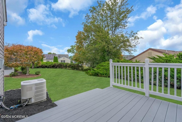 wooden deck with central AC and a lawn