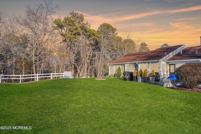 view of yard at dusk