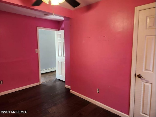 spare room with ceiling fan, wood-type flooring, and a baseboard radiator