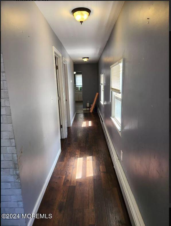 hall with dark wood-type flooring