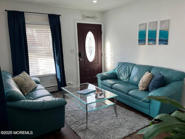 living room with dark hardwood / wood-style flooring and a baseboard heating unit