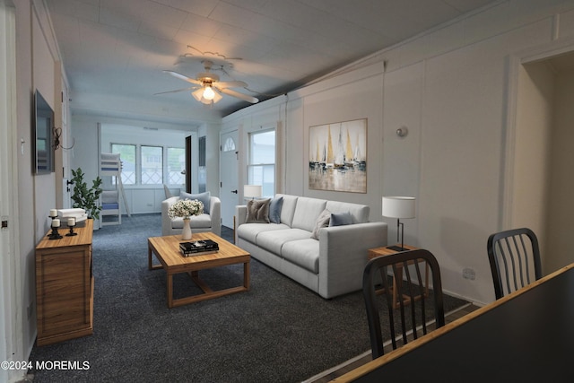 carpeted living room featuring ceiling fan and crown molding