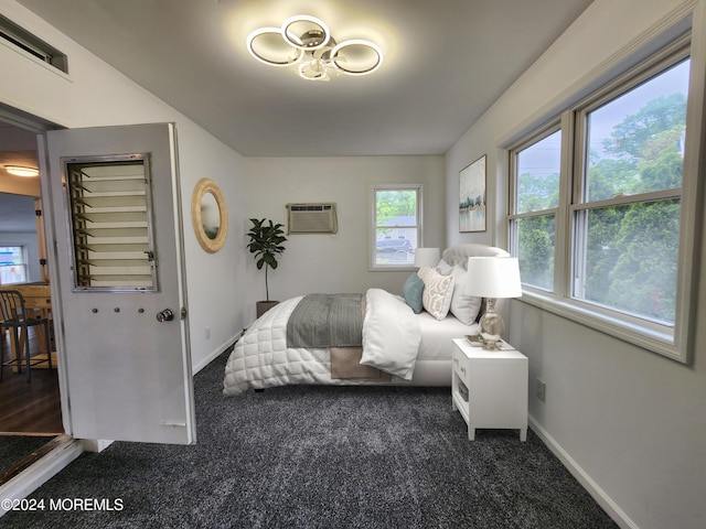 carpeted bedroom with a wall unit AC