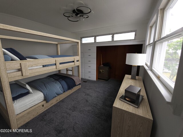 carpeted bedroom featuring multiple windows