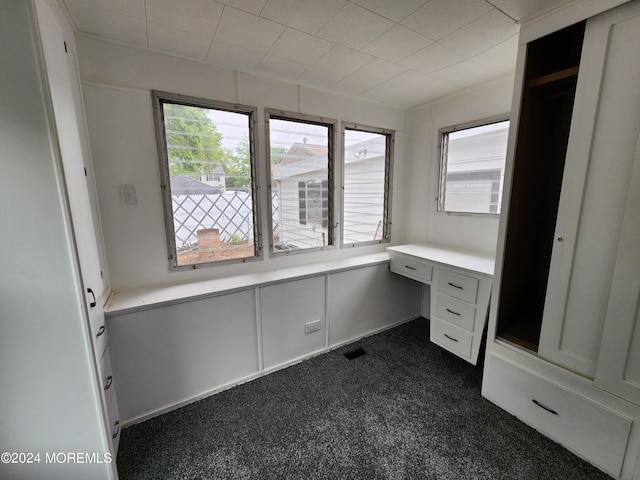 unfurnished office with dark colored carpet