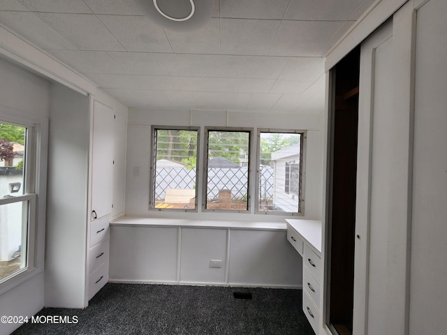 unfurnished office with dark colored carpet