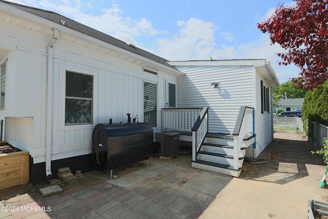 back of house with central AC unit and a patio area