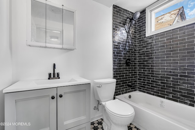 full bathroom with toilet, vanity, and tiled shower / bath combo