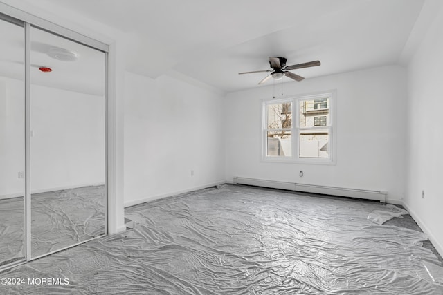 spare room with ceiling fan and baseboard heating