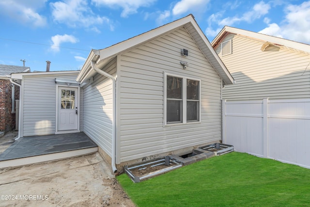 rear view of property with a lawn