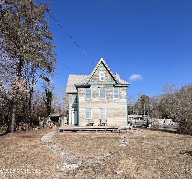 rear view of property featuring a deck