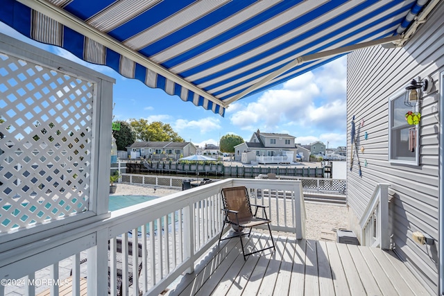 wooden terrace featuring a water view