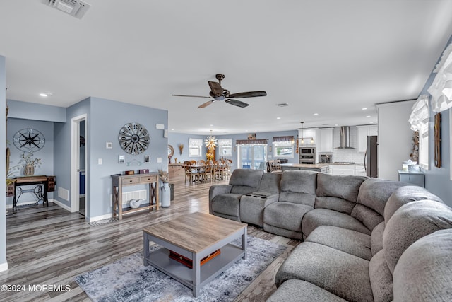 living room with ceiling fan and hardwood / wood-style floors