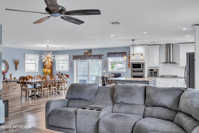 living room featuring ceiling fan and light hardwood / wood-style flooring