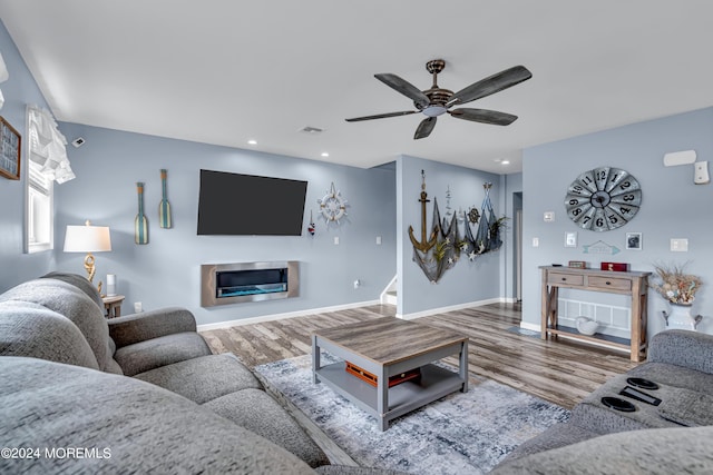 living room featuring ceiling fan and hardwood / wood-style flooring