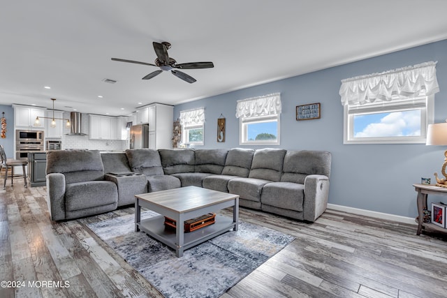 living room featuring ceiling fan and hardwood / wood-style floors