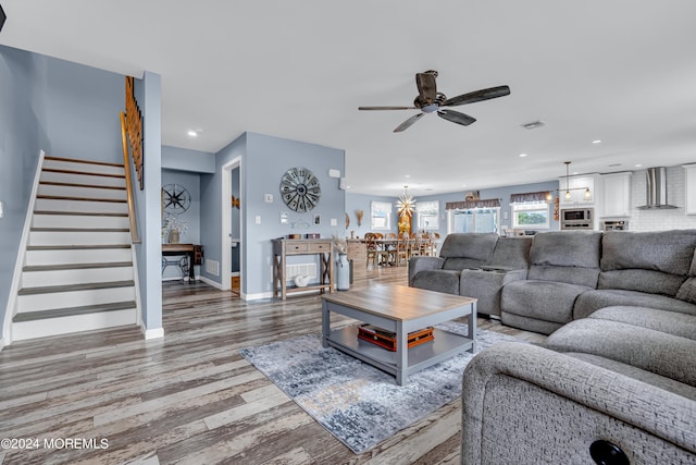 living room with ceiling fan and wood-type flooring