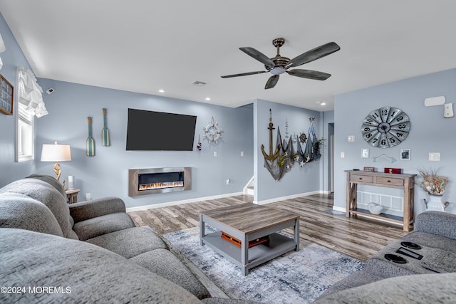 living room featuring ceiling fan and hardwood / wood-style floors