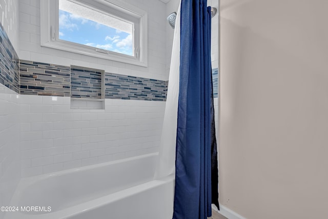 bathroom with shower / bathtub combination with curtain