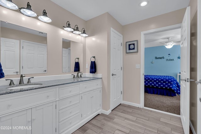 bathroom featuring ceiling fan, vanity, and hardwood / wood-style floors