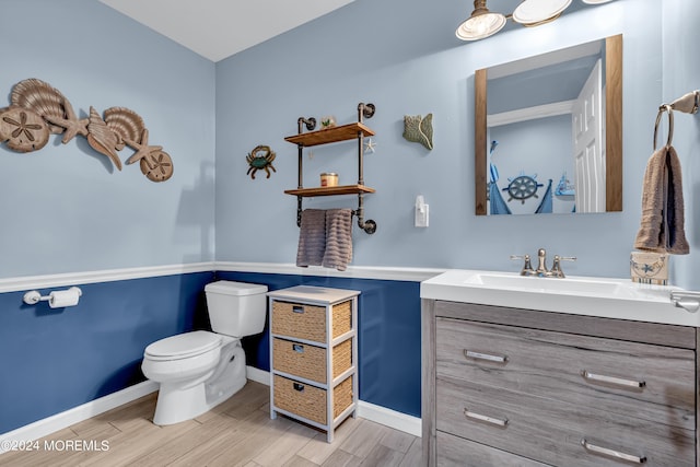 bathroom featuring toilet and vanity