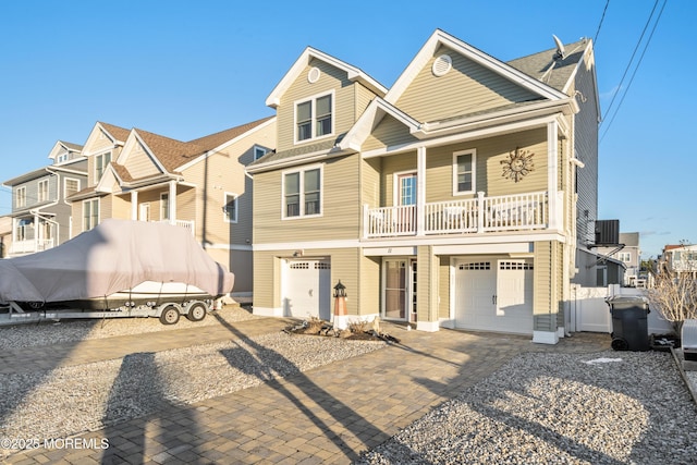 view of front facade featuring a garage and a balcony