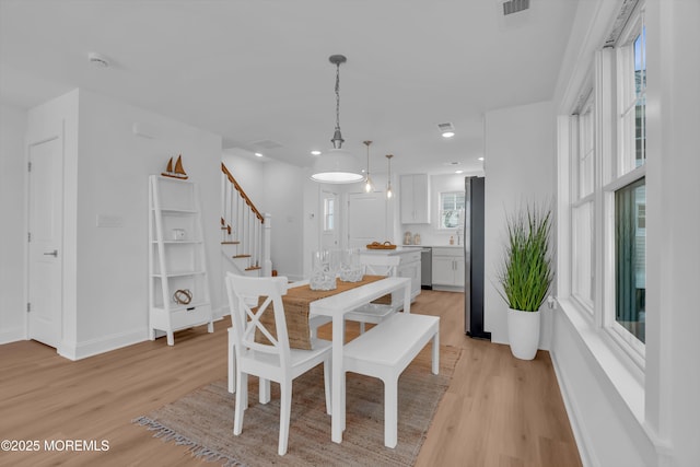 dining space with light hardwood / wood-style floors