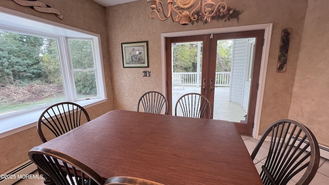 dining area featuring light tile patterned floors, baseboard heating, and french doors