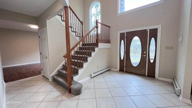 foyer featuring light tile patterned flooring and a baseboard radiator