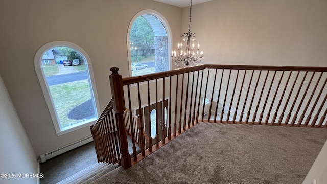 stairs featuring baseboard heating, an inviting chandelier, and carpet flooring