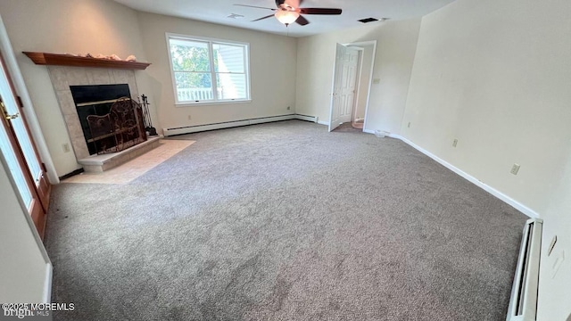 unfurnished living room featuring ceiling fan, light colored carpet, a tile fireplace, and a baseboard radiator