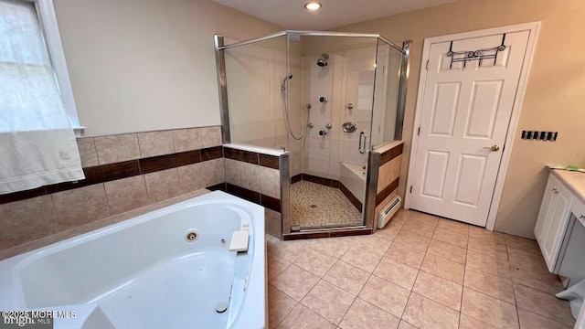 bathroom with a baseboard heating unit, vanity, separate shower and tub, and tile patterned flooring