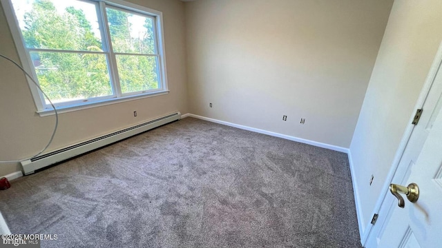 unfurnished room featuring a baseboard heating unit and carpet flooring