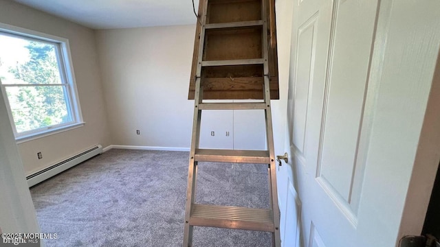 unfurnished bedroom featuring carpet, baseboard heating, and multiple windows