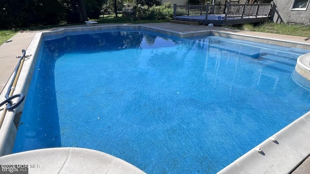 view of swimming pool with a wooden deck