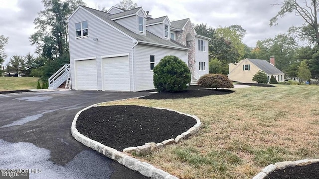 view of home's exterior with a lawn and a garage