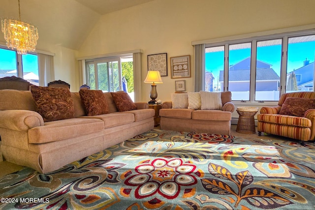 living room featuring a chandelier and lofted ceiling